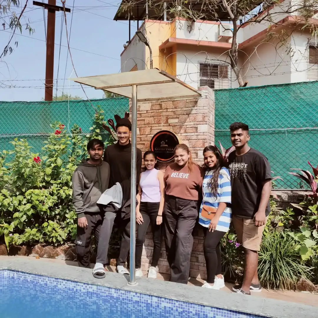 Happy guest relaxing by the pool at Govind Villa