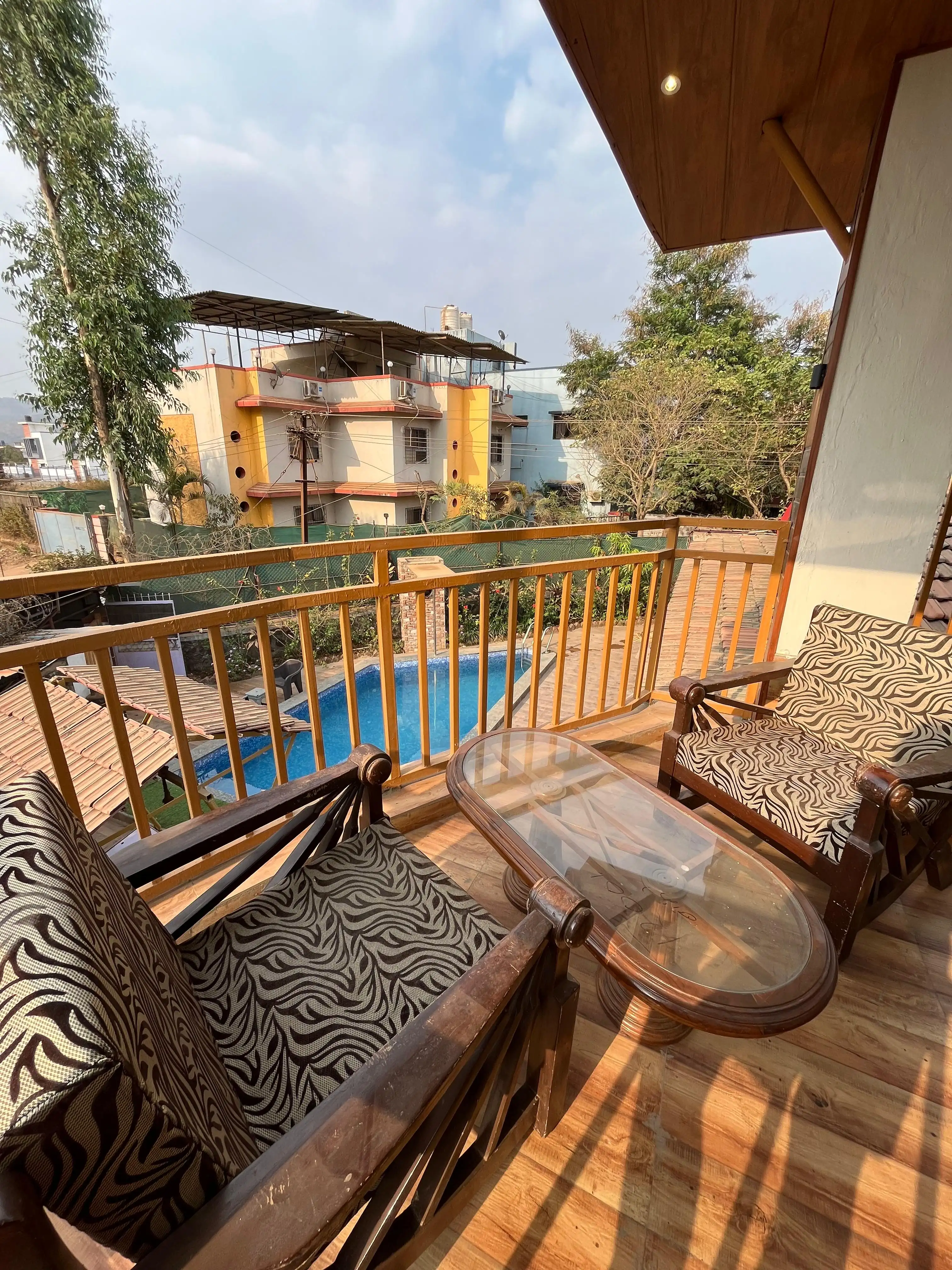 View of the Govind Villa balcony with a stunning pool view, ideal for relaxation and leisure.